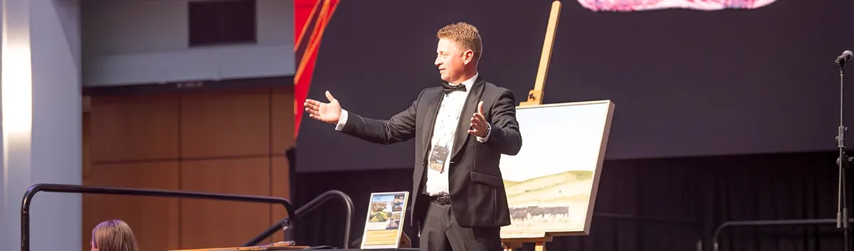 A speaker addressing guests at an AWA industry dinner